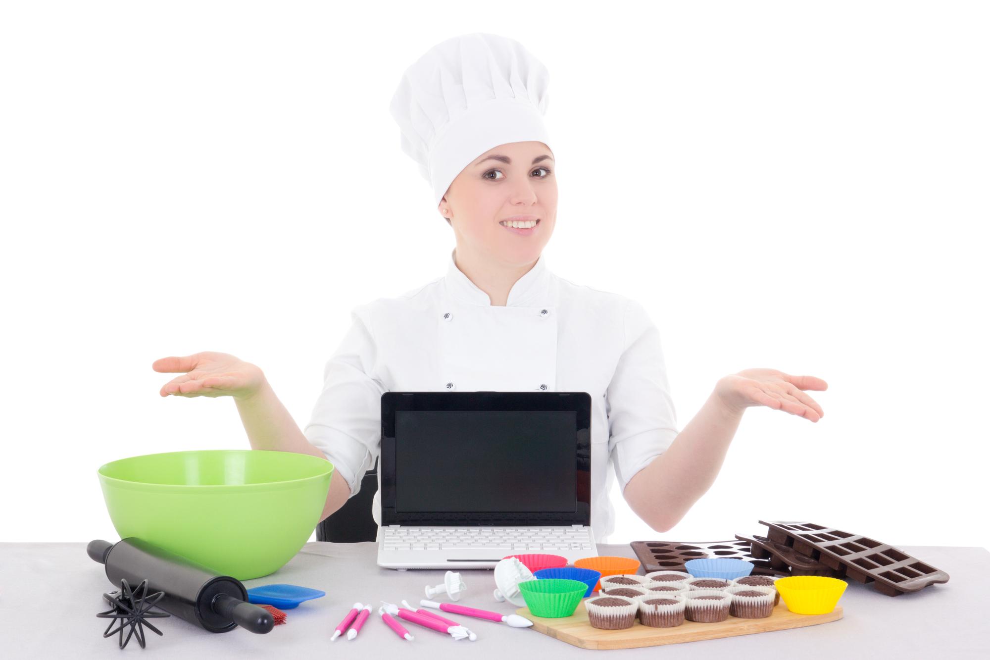 Student plating a dish in a studio kitchen